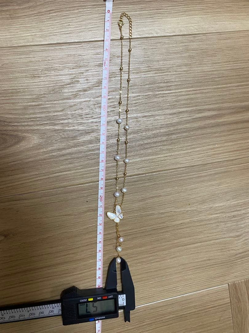 White pearl necklace with white mother-of-pearl butterfly pendant and 5.7mm freshwater pearls on 46cm chain
