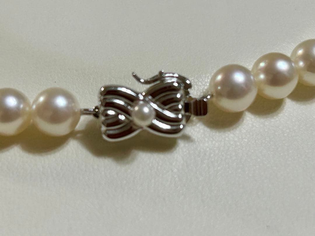 Tasaki Akoya pearl necklace with 7mm pearls and 42cm length featuring a branded clasp