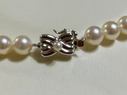 Tasaki Akoya pearl necklace with 7mm pearls and 42cm length featuring a branded clasp