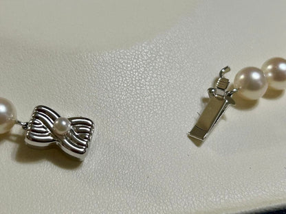 Tasaki Akoya pearl necklace with 7mm pearls and 42cm length featuring a branded clasp