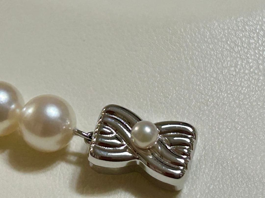 Tasaki Akoya pearl necklace with 7mm pearls and 42cm length featuring a branded clasp