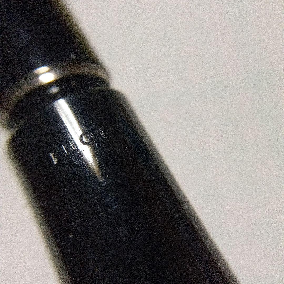 Black Pilot Desk Pen with 14K gold nib showing scratches and discoloration, accompanied by damaged storage box