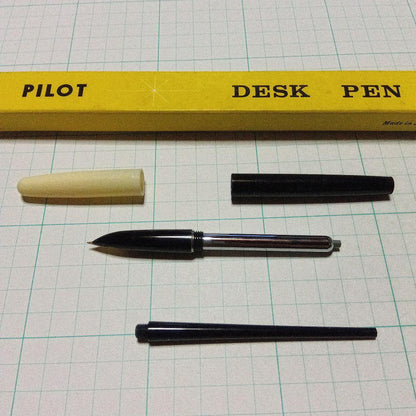 Black Pilot Desk Pen with 14K gold nib showing scratches and discoloration, accompanied by damaged storage box