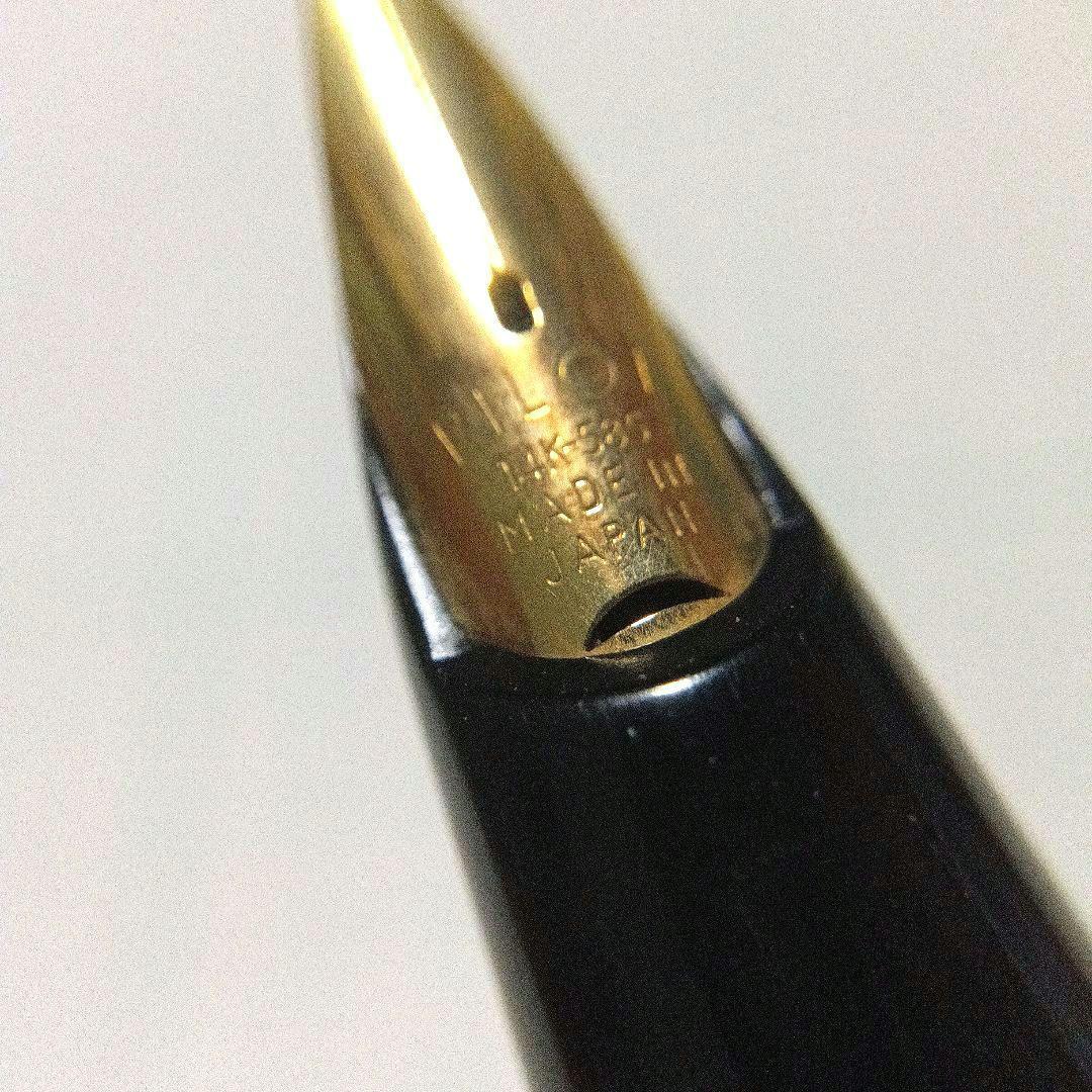 Black Pilot Desk Pen with 14K gold nib showing scratches and discoloration, accompanied by damaged storage box