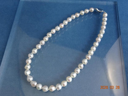 Akoya pearl necklace featuring 8.5-9mm pearls and a silver one-touch clasp on a white background