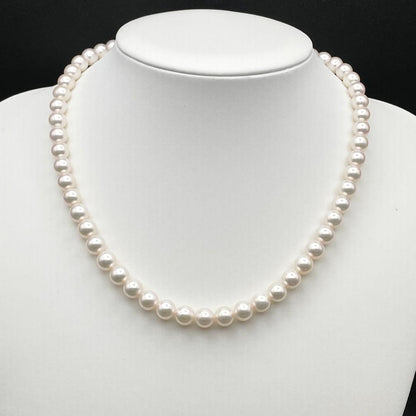 Tasaki Akoya pearl necklace with 7.0-7.5mm pearls and silver clasp on a white background