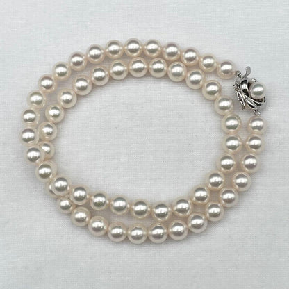 Tasaki Akoya pearl necklace with 7.0-7.5mm pearls and silver clasp on a white background