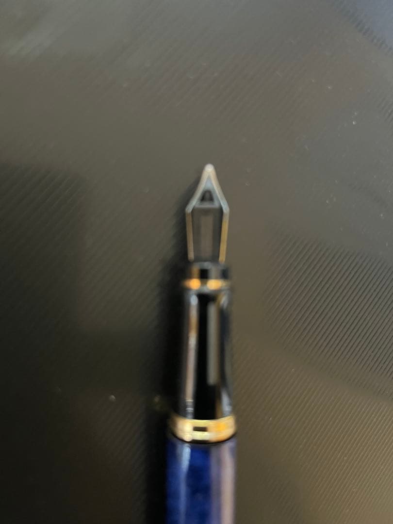 Waterman fountain pen with blue marble finish, gold trim, and medium gold nib on white background
