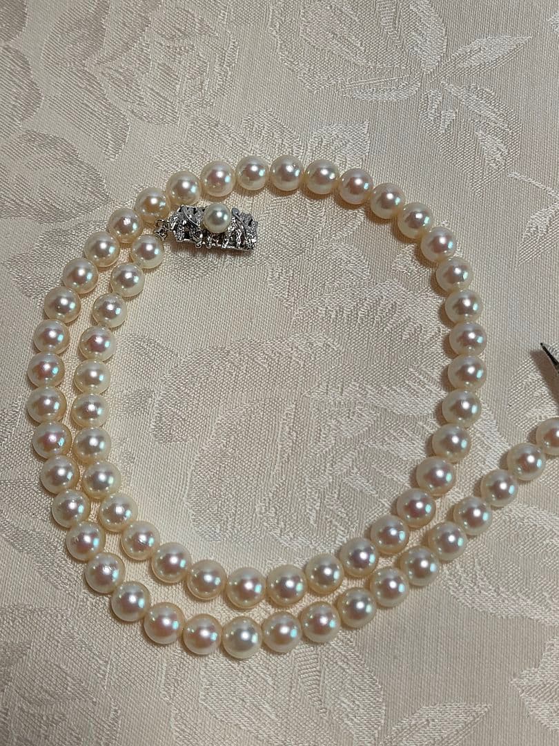 Akoya pearl necklace with 6.5-6.7mm cream-toned pearls and square silver clasp on a white background