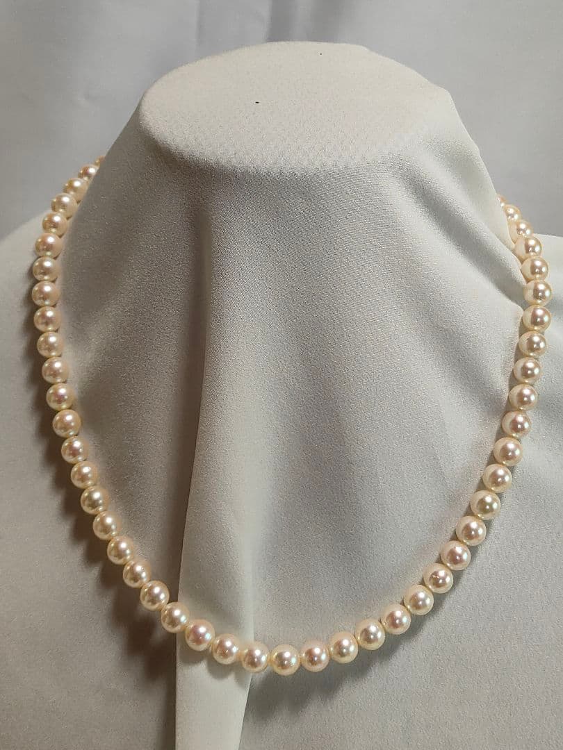 Akoya pearl necklace with 6.5-6.7mm cream-toned pearls and square silver clasp on a white background