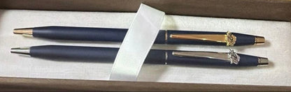 Cross 2-piece ballpoint pen set in gold and silver with navy accents, displayed with gift box and manual