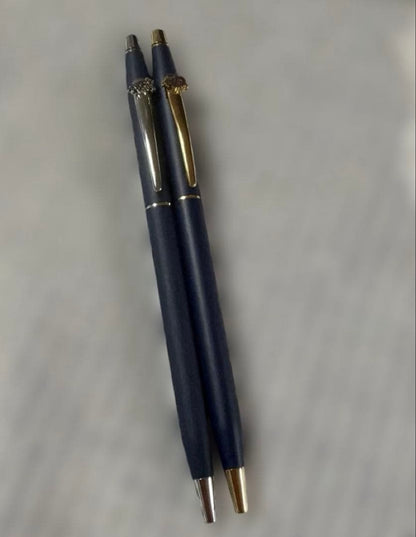 Cross 2-piece ballpoint pen set in gold and silver with navy accents, displayed with gift box and manual