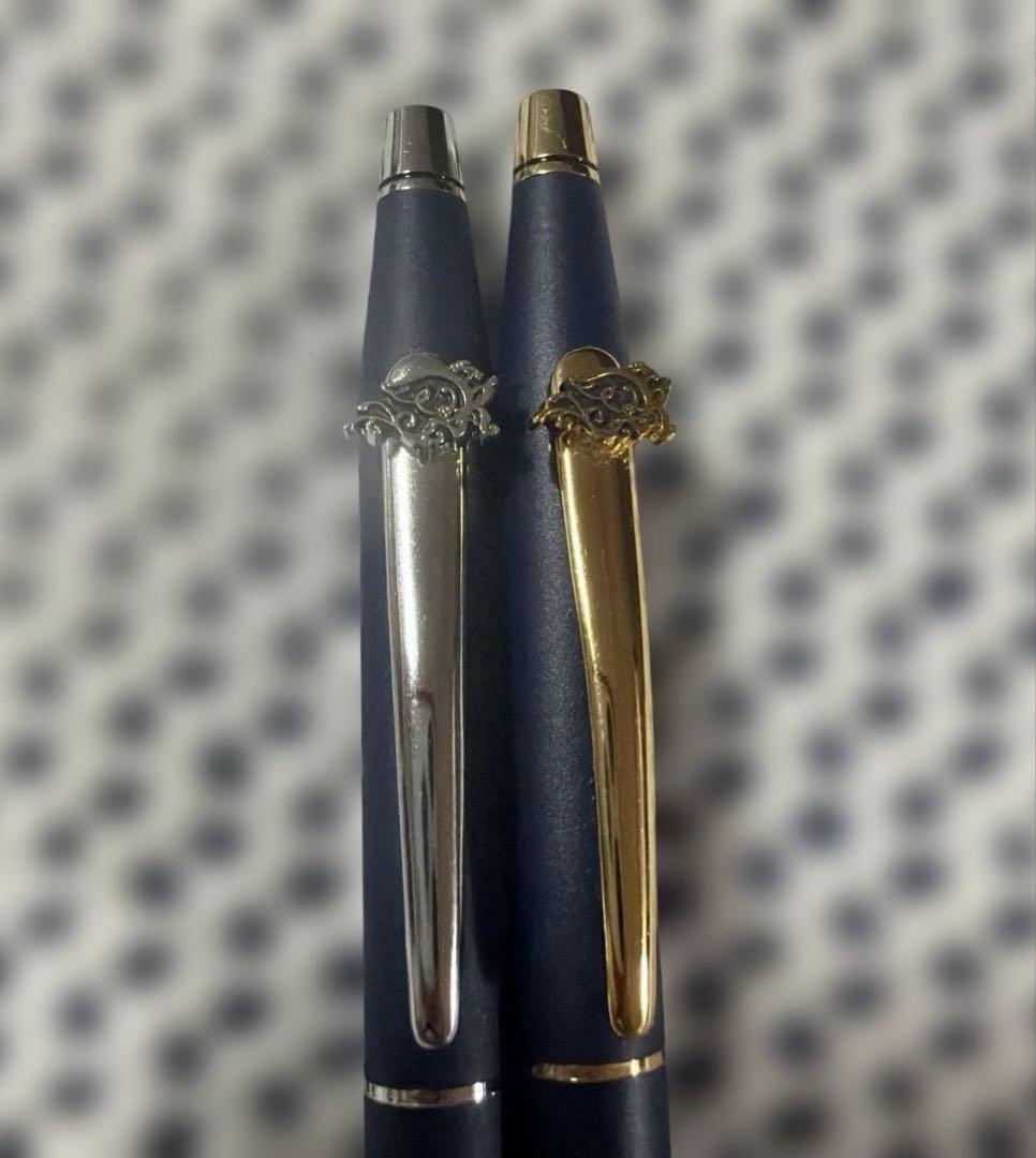 Cross 2-piece ballpoint pen set in gold and silver with navy accents, displayed with gift box and manual