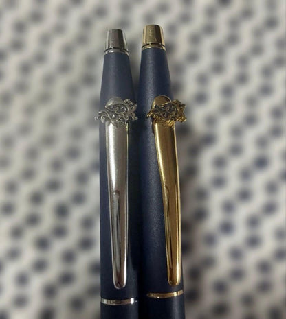 Cross 2-piece ballpoint pen set in gold and silver with navy accents, displayed with gift box and manual