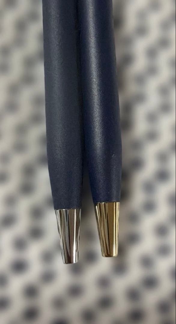 Cross 2-piece ballpoint pen set in gold and silver with navy accents, displayed with gift box and manual