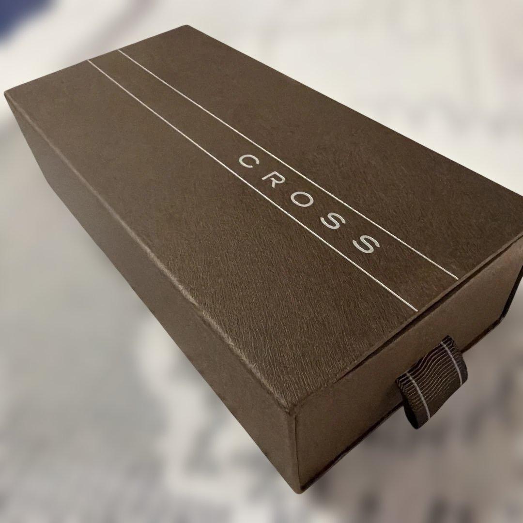 Cross 2-piece ballpoint pen set in gold and silver with navy accents, displayed with gift box and manual