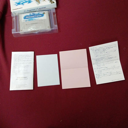 Super Famicom Bahamut Lagoon game with box, manual, advertisement, and dedicated postcard