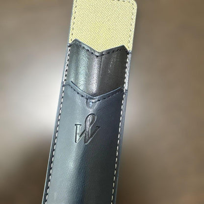 Used Waterman black ballpoint pen with a leather case showing a dent