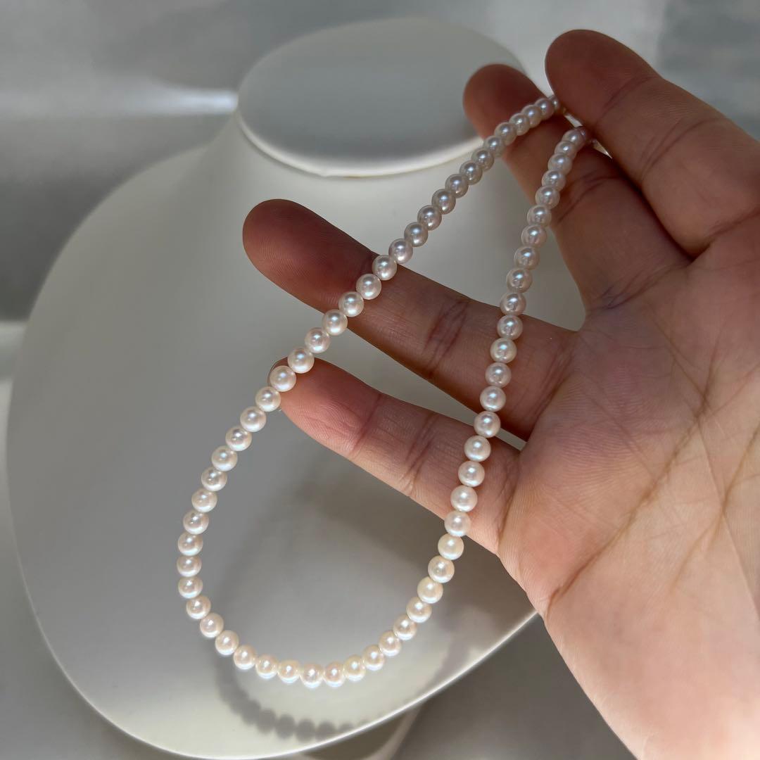 Close-up of Akoya pearl necklace featuring 4-4.5mm lustrous white pearls on a delicate strand