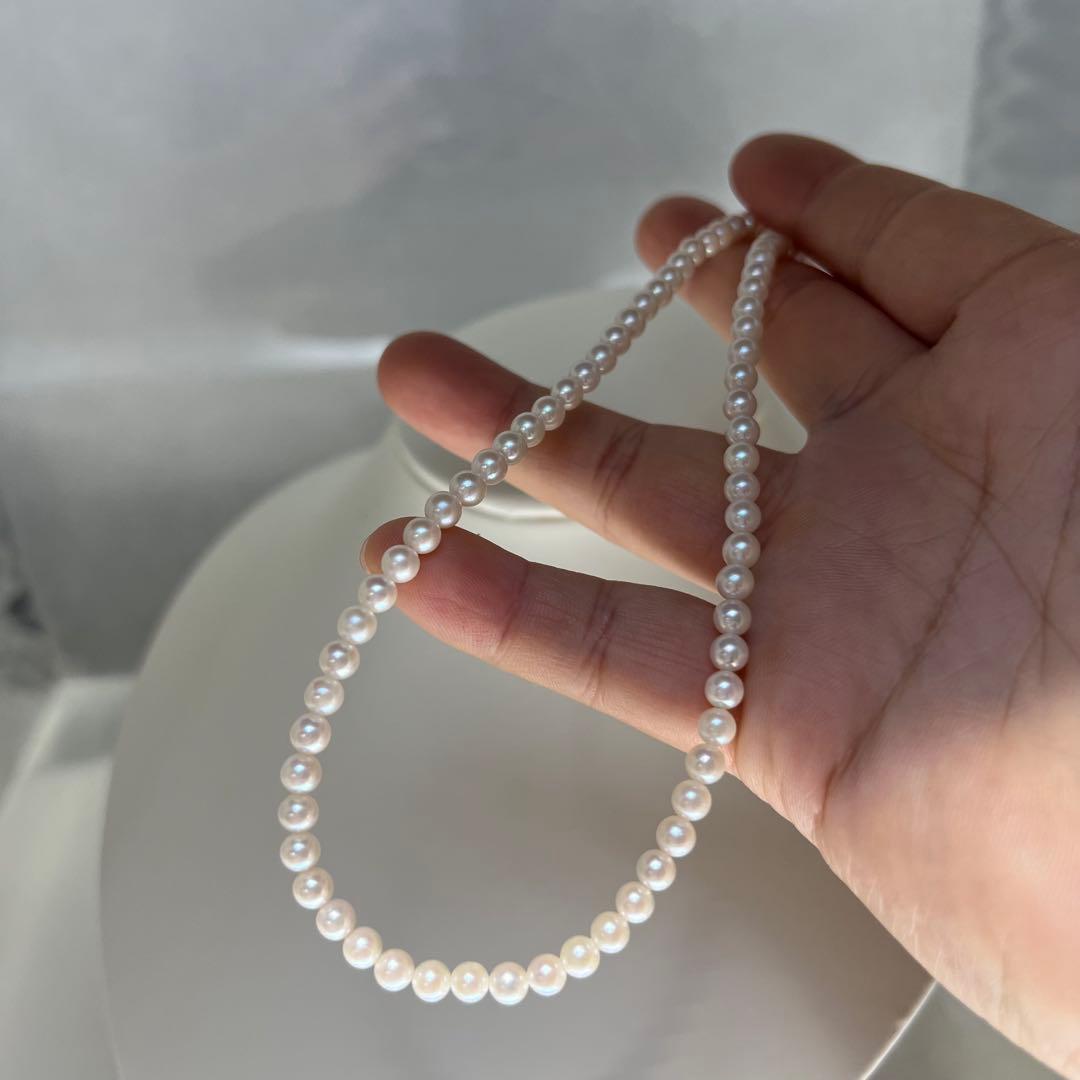 Close-up of Akoya pearl necklace featuring 4-4.5mm lustrous white pearls on a delicate strand