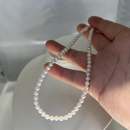 Close-up of Akoya pearl necklace featuring 4-4.5mm lustrous white pearls on a delicate strand