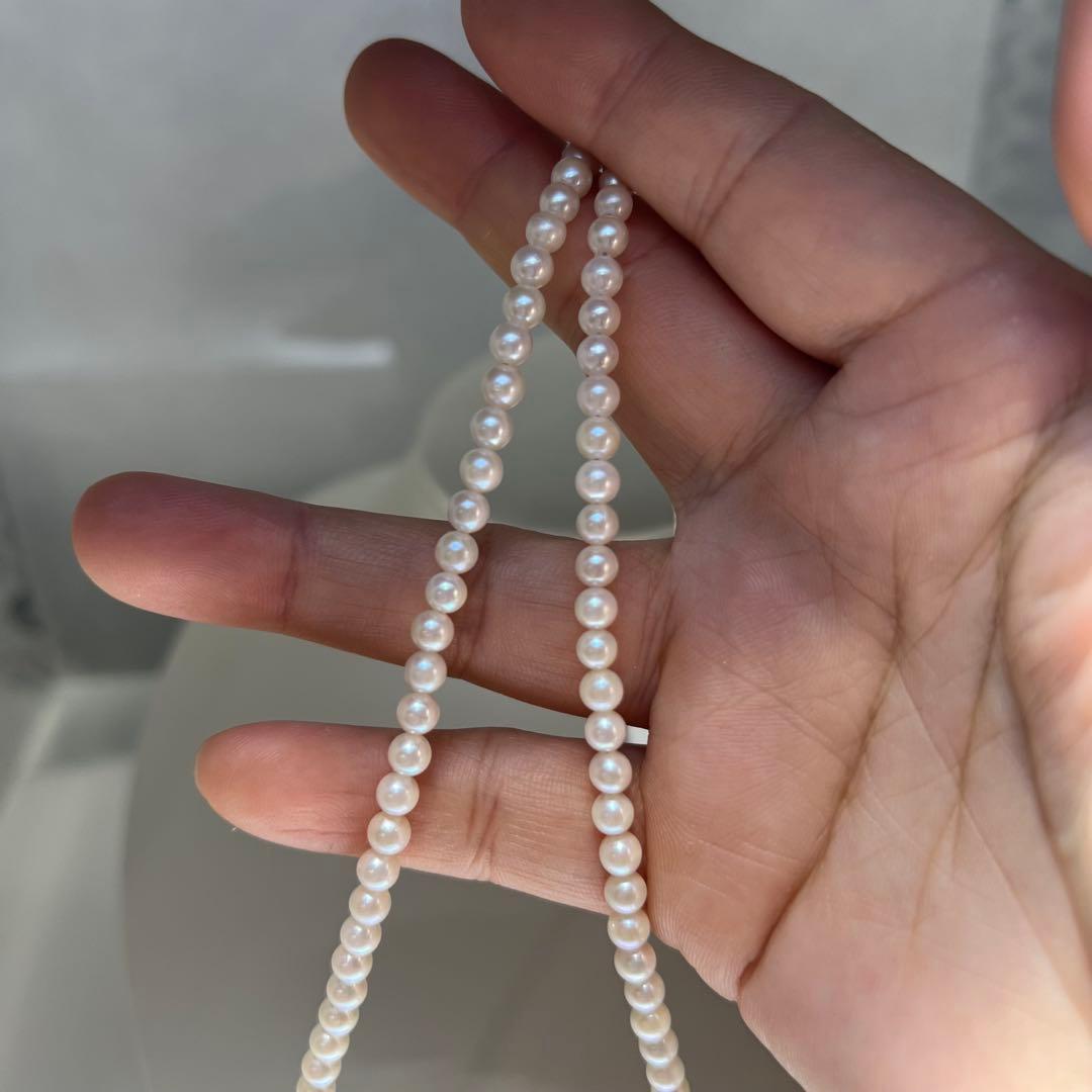 Close-up of Akoya pearl necklace featuring 4-4.5mm lustrous white pearls on a delicate strand
