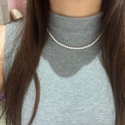 Close-up of Akoya pearl necklace featuring 4-4.5mm lustrous white pearls on a delicate strand