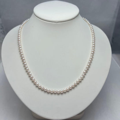 Close-up of Akoya pearl necklace featuring 4-4.5mm lustrous white pearls on a delicate strand
