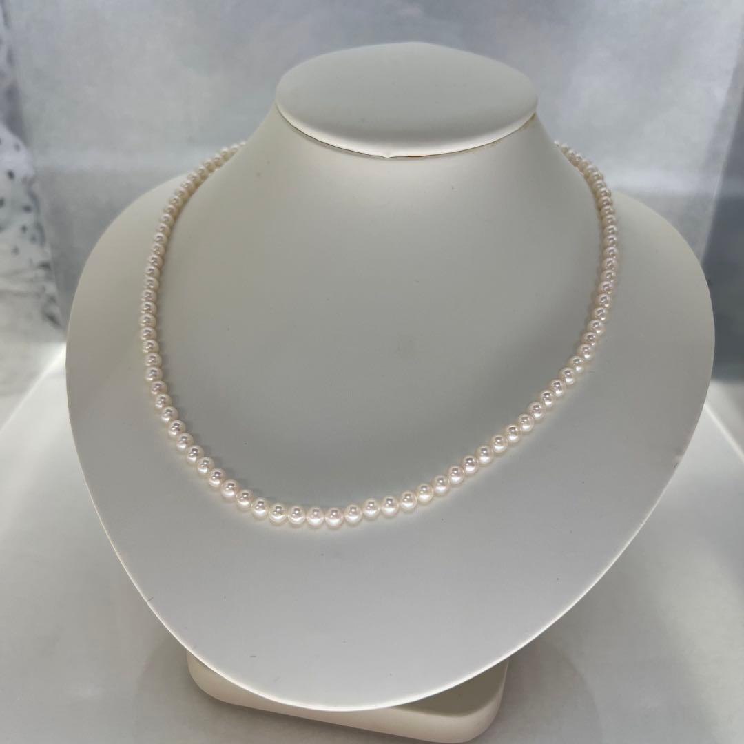 Close-up of Akoya pearl necklace featuring 4-4.5mm lustrous white pearls on a delicate strand