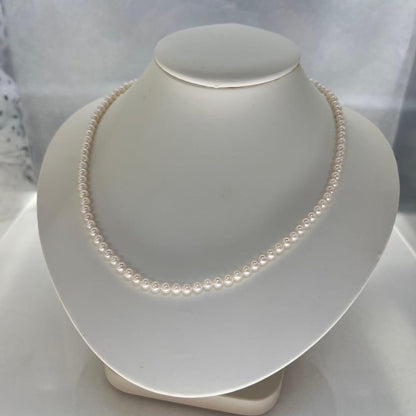 Close-up of Akoya pearl necklace featuring 4-4.5mm lustrous white pearls on a delicate strand