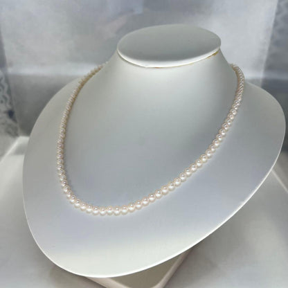 Close-up of Akoya pearl necklace featuring 4-4.5mm lustrous white pearls on a delicate strand