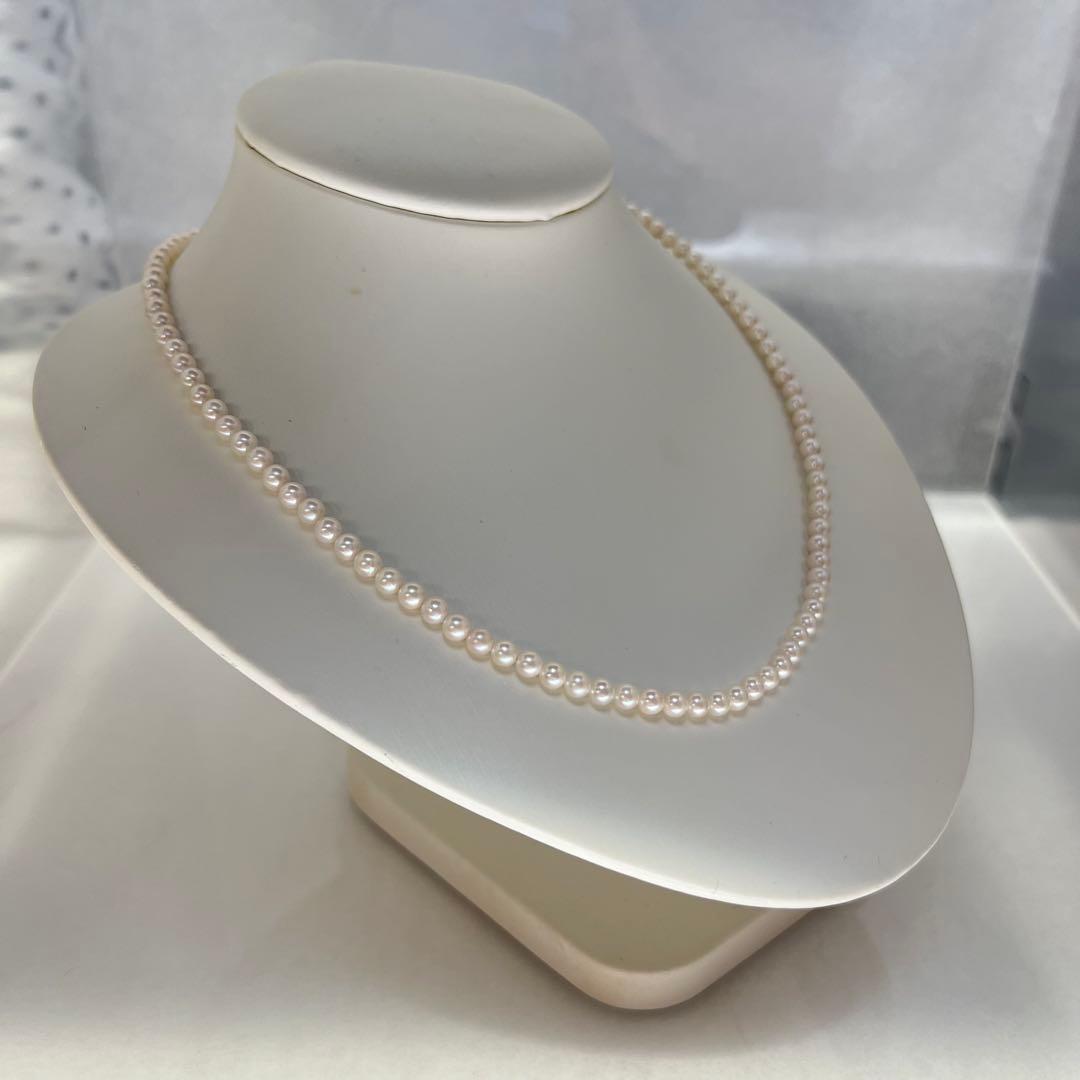 Close-up of Akoya pearl necklace featuring 4-4.5mm lustrous white pearls on a delicate strand