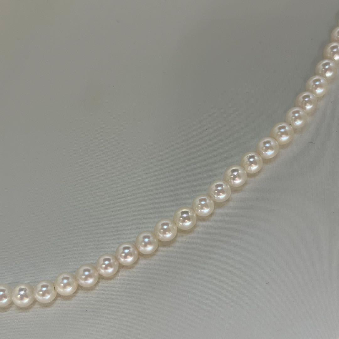 Close-up of Akoya pearl necklace featuring 4-4.5mm lustrous white pearls on a delicate strand