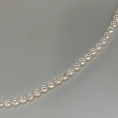 Close-up of Akoya pearl necklace featuring 4-4.5mm lustrous white pearls on a delicate strand