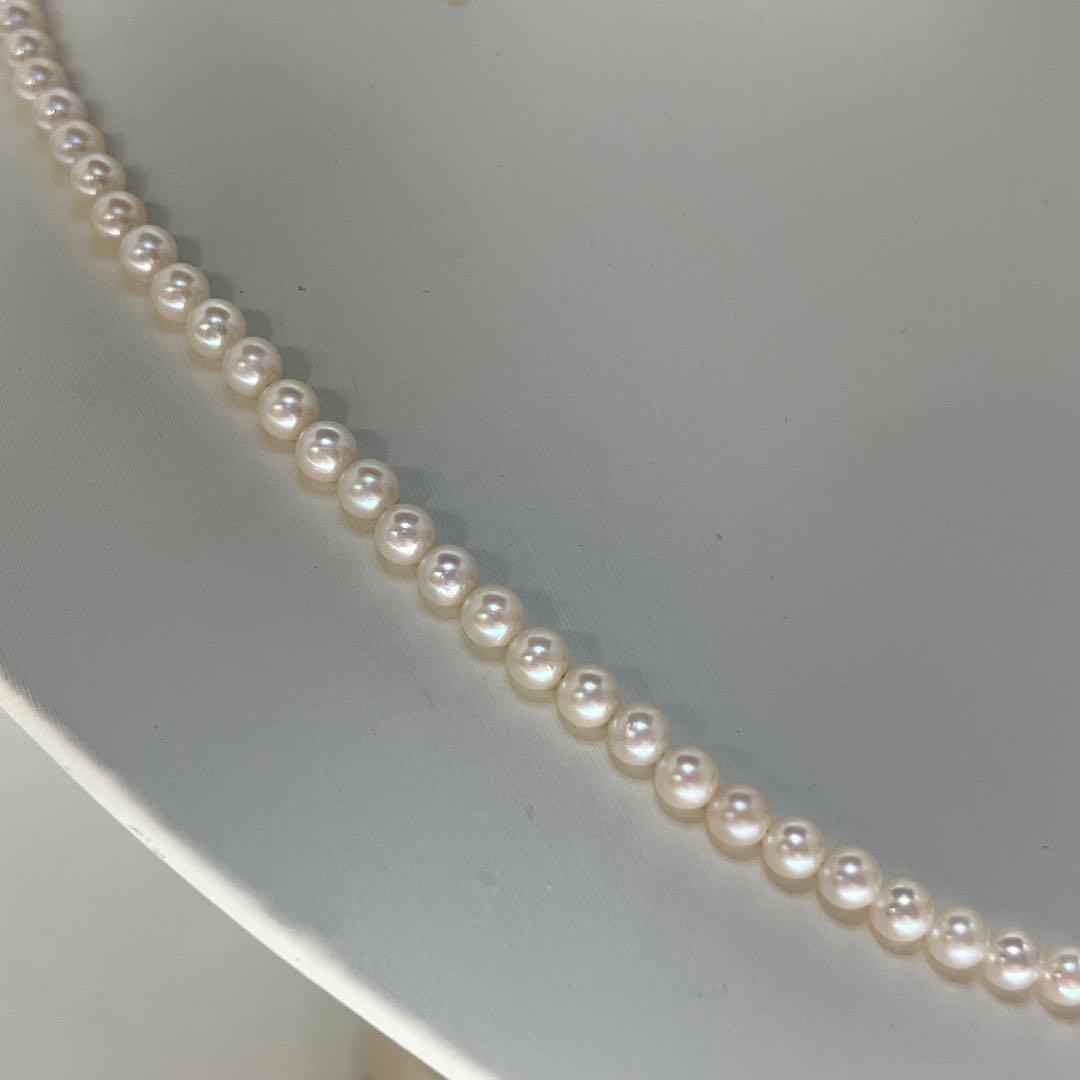 Close-up of Akoya pearl necklace featuring 4-4.5mm lustrous white pearls on a delicate strand