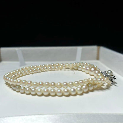 Akoya pearl necklace with round white pearls 3.3-7.4mm and silver stamp on a 45cm chain
