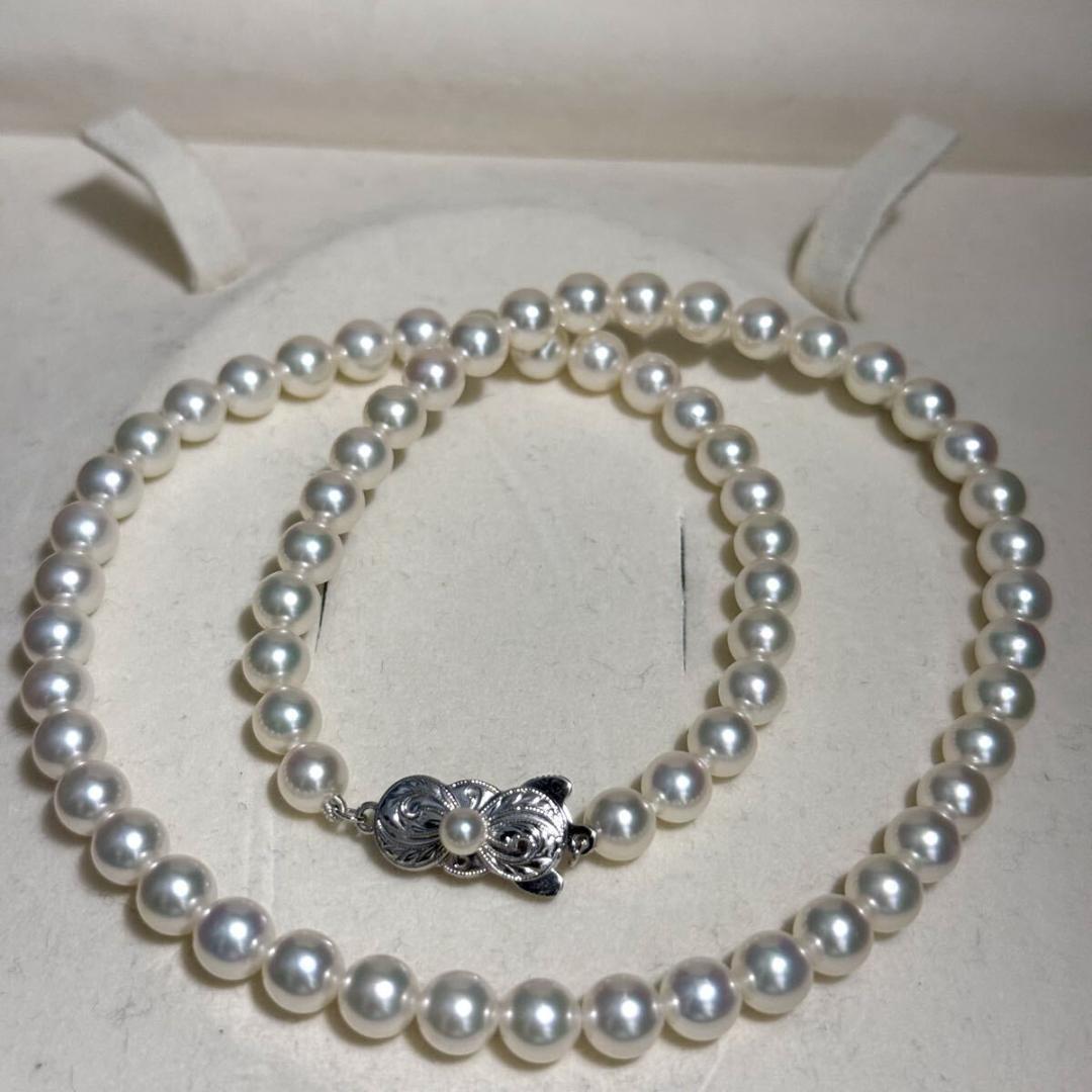 Mikimoto Akoya pearl necklace with 6.5mm pearls and silver clasp on a white background