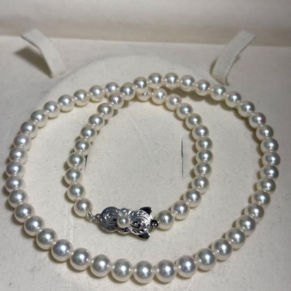 Mikimoto Akoya pearl necklace with 6.5mm pearls and silver clasp on a white background