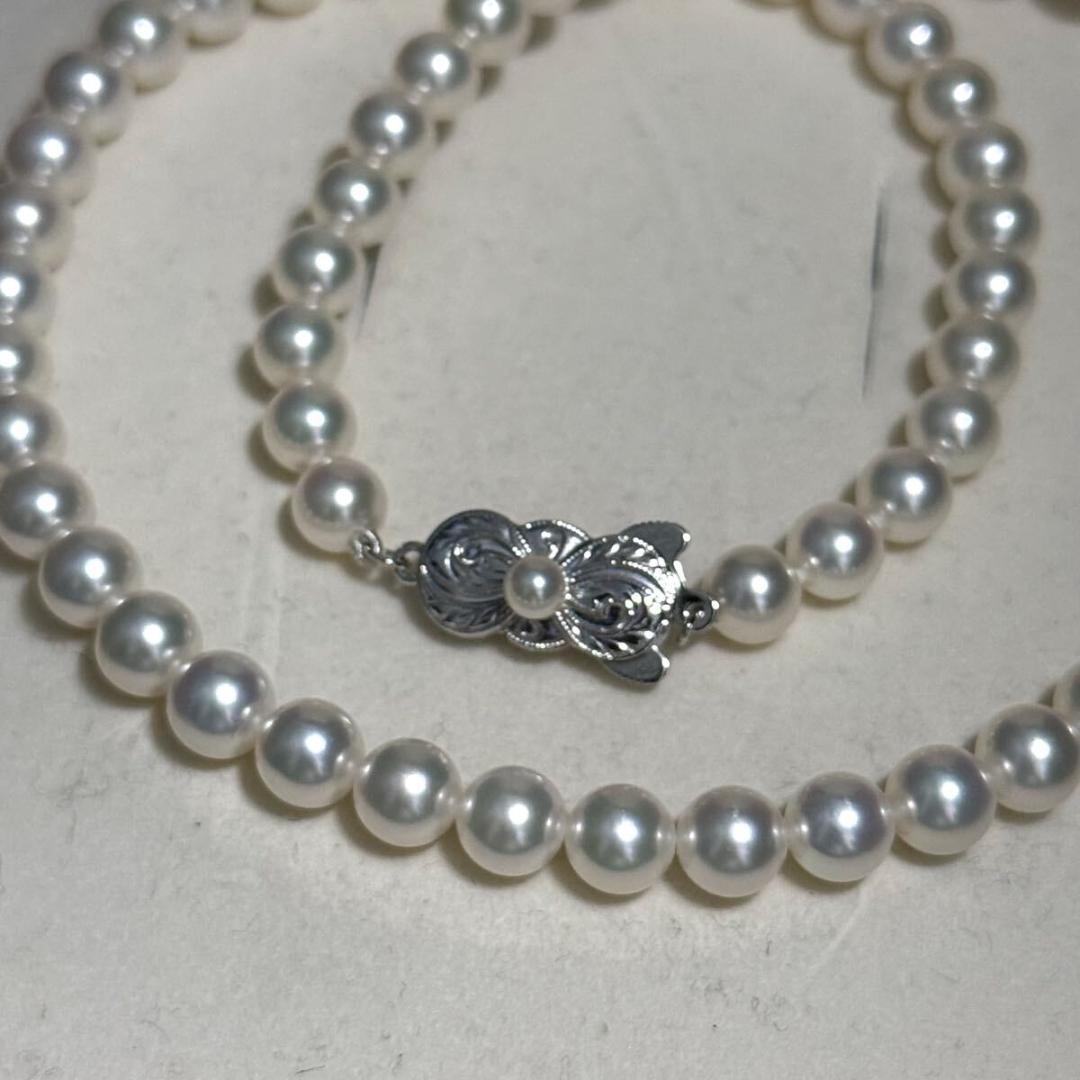 Mikimoto Akoya pearl necklace with 6.5mm pearls and silver clasp on a white background