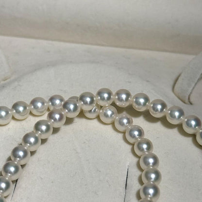 Mikimoto Akoya pearl necklace with 6.5mm pearls and silver clasp on a white background