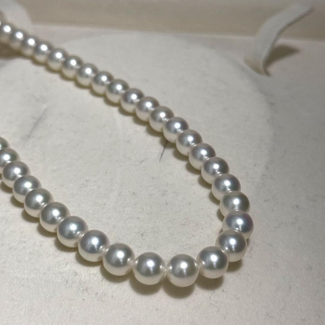 Mikimoto Akoya pearl necklace with 6.5mm pearls and silver clasp on a white background