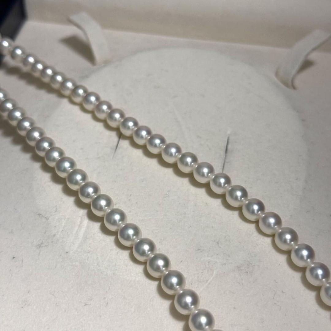 Mikimoto Akoya pearl necklace with 6.5mm pearls and silver clasp on a white background
