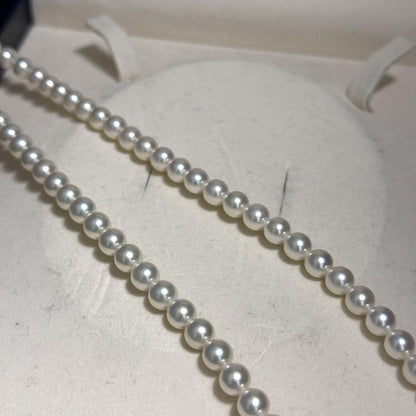 Mikimoto Akoya pearl necklace with 6.5mm pearls and silver clasp on a white background