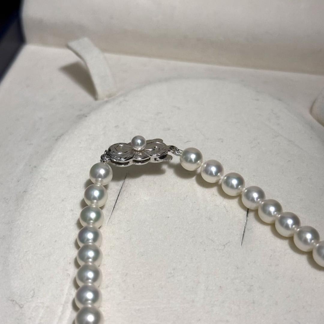 Mikimoto Akoya pearl necklace with 6.5mm pearls and silver clasp on a white background