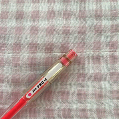 Pilot Hi-Tec C ballpoint pen in fluorescent pink with ink visible, discontinued edition