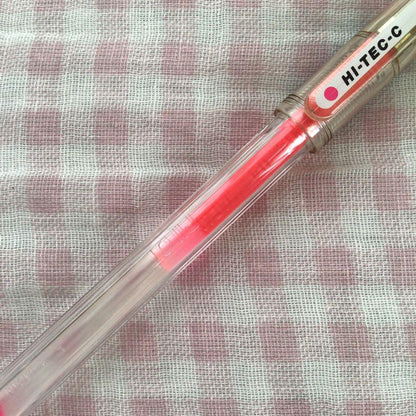 Pilot Hi-Tec C ballpoint pen in fluorescent pink with ink visible, discontinued edition