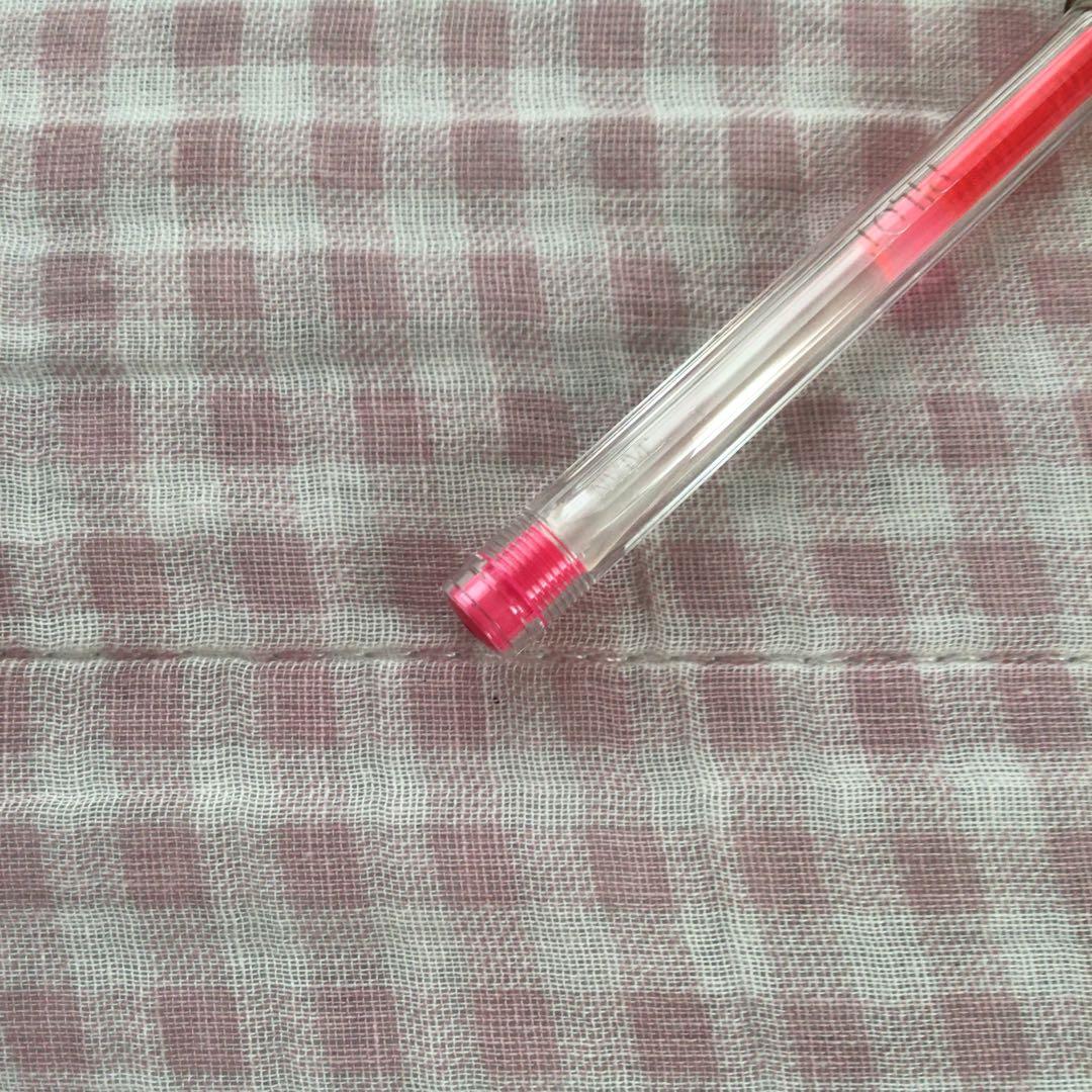 Pilot Hi-Tec C ballpoint pen in fluorescent pink with ink visible, discontinued edition