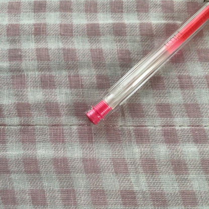 Pilot Hi-Tec C ballpoint pen in fluorescent pink with ink visible, discontinued edition