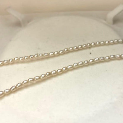 K18 gold necklace with natural white Akoya baby pearls sized 2.5-3mm on a 39cm chain