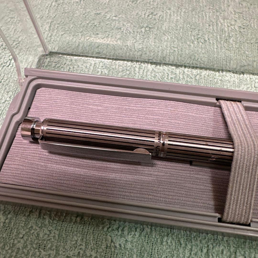 Silver Pilot Switch key-engraved pen with fine tip and stripe design beside its case